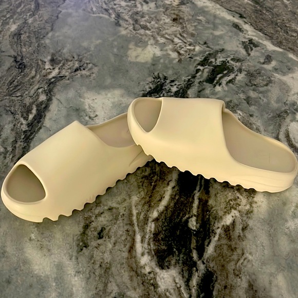 these are Yeezy slides, they are a cream color and they have never used before
